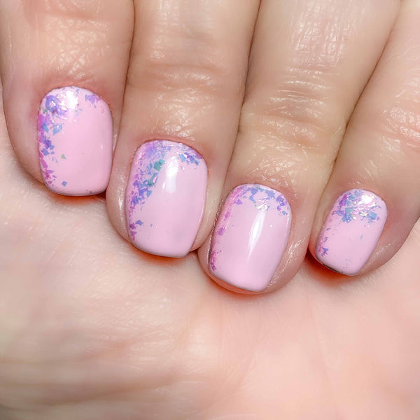 Pink nail art flakes over babydoll gel