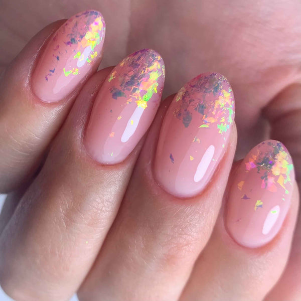 Pink nail art flakes over pink gel